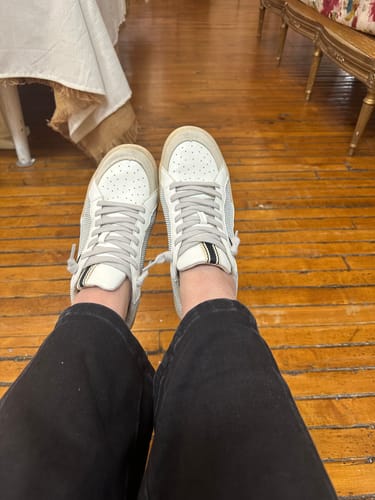 Customer's point-of-view wearing the SALMA sneakers in Grey Mesh with black pants on a wood floor.