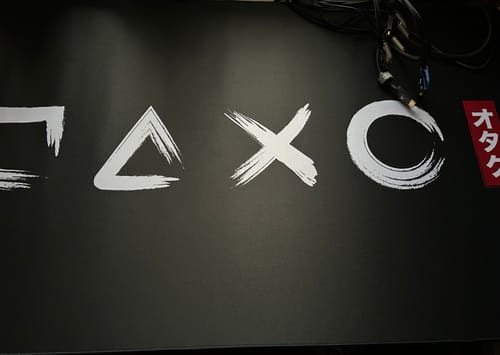 Customer's black Gamer Ink mousepad showing the PlayStation symbols in a white Japanese sketch style.