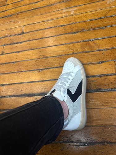 Side view of the customer's SALMA sneaker, showing the distinctive black accent panel against the grey mesh.