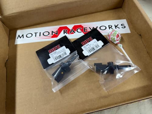 Customer's two RIFE Hi IAT Air Temperature Sensors in their packaging inside a Motion Raceworks box.