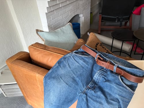 Reviewer's handsome Heritage Bison belt with its copper buckle, threaded through a pair of blue jeans.