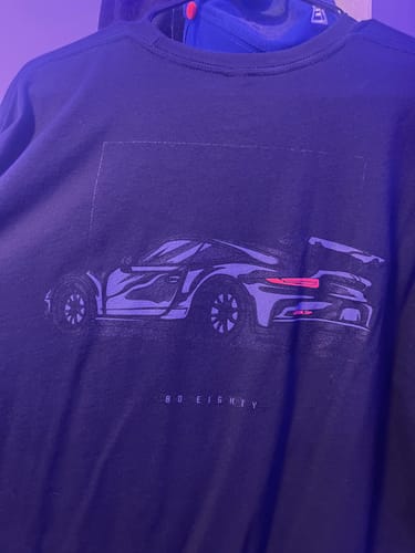 Reviewer's close-up of the sports car graphic on their black 80Eighty DCG85 Shirt.