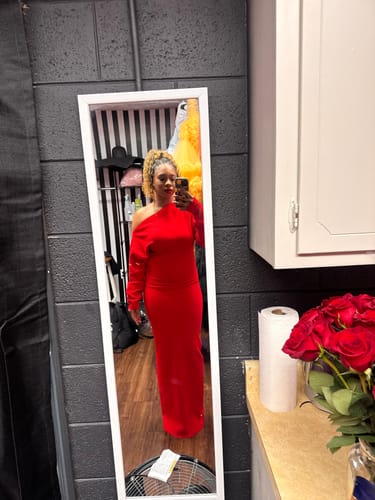 Customer taking a mirror selfie in a red Knit Off-Shoulder Sweater Maxi Dress in a dressing room.