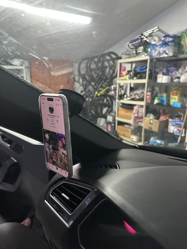 Customer's MagMount Pro with a strong suction cup attached to a car windshield, securely holding a phone.