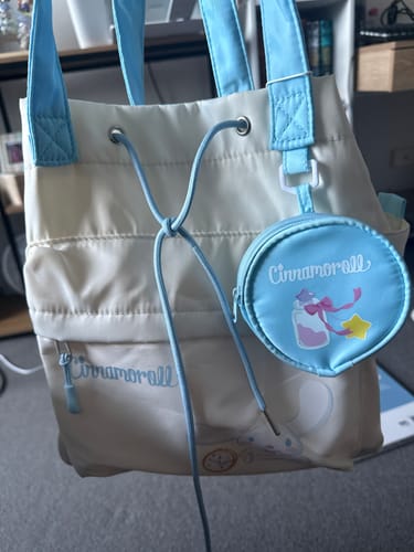 Customer's beige Sanrio Cinnamoroll tote bag with light blue straps and the matching round pouch.
