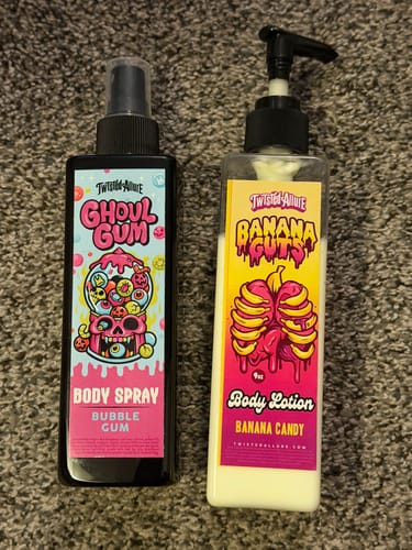 Reviewer's Ghoul Gum Body Spray sits next to a bottle of Banana Guts Body Lotion on a carpet.