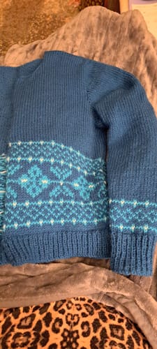 Reviewer's blue sweater knitted from the box's wool, showing off the Fair Isle pattern.