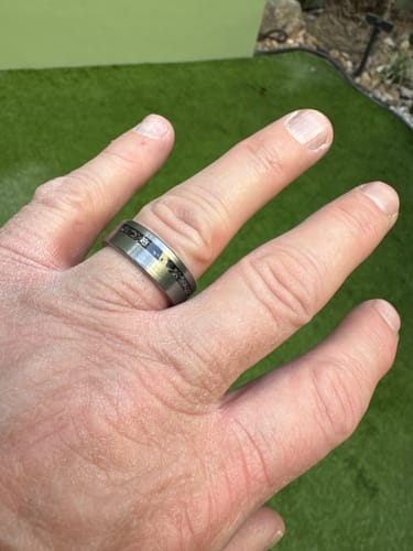 Customer's hand wearing the Thor ring, showing the detail of the meteorite inlay and brushed tungsten band.