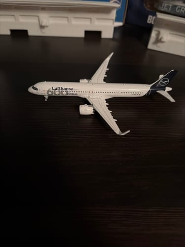 Customer's Gemini Lufthansa A321NEO model airplane displayed on a dark surface, shown as part of a collection.