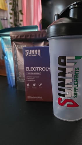 Reviewer's order of Sunna Supplements, including a shaker, electrolytes, and creatine, arranged on a dark surface.