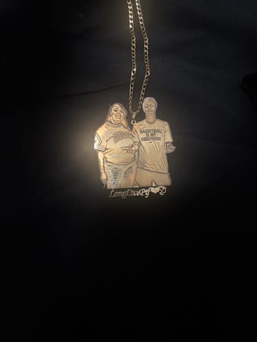 Customer's gold-colored Custom Photo Engraved Pendant Necklace with a detailed cutout engraving of two people.