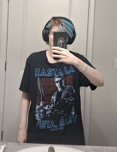Reviewer taking a mirror selfie wearing the Hasta La Vista, Baby Terminator 2 T-Shirt.