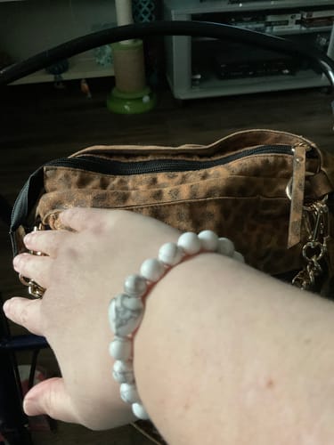 Customer's wrist showing a white howlite bracelet with a heart-shaped bead.