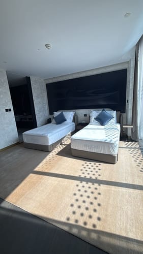 Customer's two elegant Single Size Bed B030s with beige bases set up in a modern bedroom.