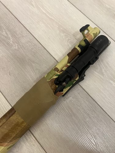 Customer's OD Green Raid Tape wrapped around a camouflage firearm for wire retention.