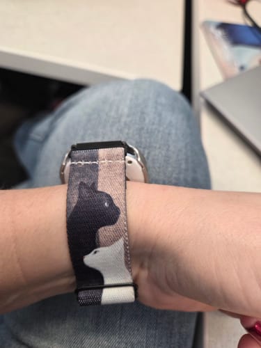 Customer wearing the Purrfect Balance Watchband on their wrist, showing its black and white cat design.