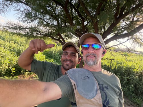 Reviewer and a friend taking a selfie outdoors, both wearing their black XCOR earbuds.