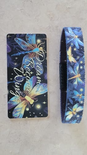 Customer's Dreams Become Wings Bracelet laid flat next to its matching card, both with a colorful dragonfly design.
