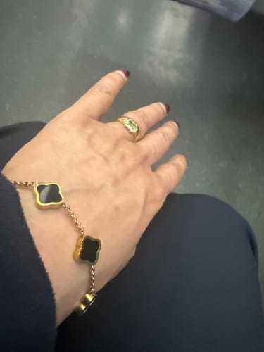 Customer's review image for the Luxury Gift Box, showing a bracelet with black clover charms on a wrist.