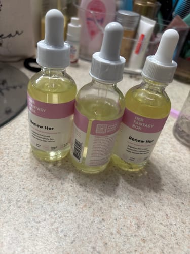 Customer's three glass dropper bottles of Renew Her Booty & Kitty Oil on a bathroom counter.