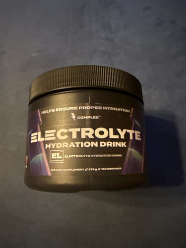 Customer's photo of the black tub of Complex Electrolyte Hydration Drink on a dark surface.