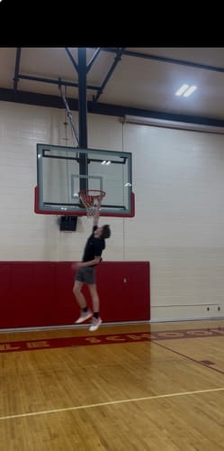 Reviewer jumping high toward a basketball hoop in their Joker 1 GT "Peppa Pig" shoes.