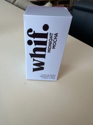 Customer's white and black box of Midnight Mocha perfume standing on a tabletop.