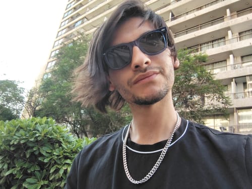 Cliente usando su Cadena Cuban Link de 8mm en una selfie al aire libre.