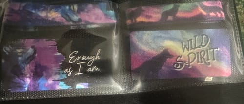 Customer shows the colorful 'Enough As I Am' and 'Wild Spirit' bracelets from the Wolf Pack in their packaging.