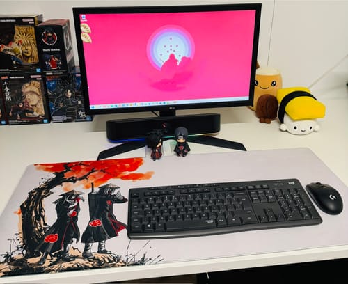 Reviewer's large Red Cloud Shinobi mouse mat on a desk, with a keyboard and mouse on top, showing the detailed fan art design.