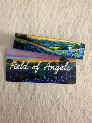 Customer's Field of Angels bracelet displaying a beautiful blue flower landscape, shown with its card.
