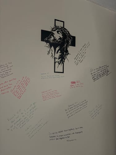 Customer's Crown of Thorns Jesus Cross metal decor on a wall, surrounded by handwritten Bible verses from the reviewer.