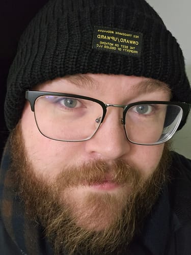 Customer in a close-up photo wearing the black Big Beefy Cable Knit Beanie.