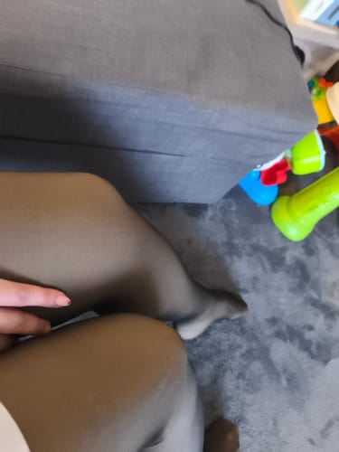 Une cliente assise montre l'effet transparent de son collant polaire noir sur ses jambes.