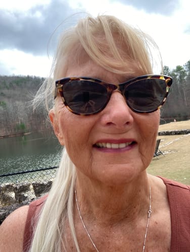 Close-up of a smiling reviewer outdoors who takes Colagene for joint mobility.