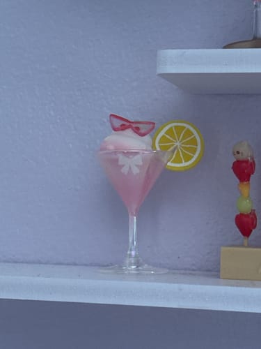 Customer's Emmmkun Enjoy Summer Series blind box figure of a pink drink in a martini glass on a shelf.