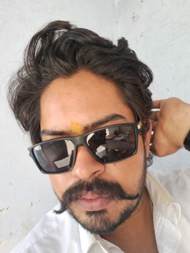 A close-up of a customer wearing the matte black and golden Jaxor rectangle sunglasses.