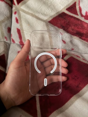 Customer holding a clear phone case with a visible MagSafe charging ring in their hand.