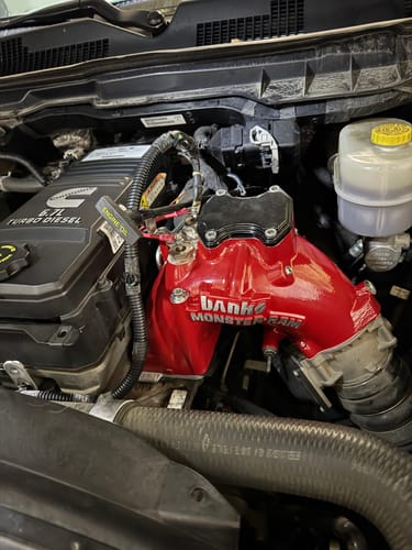 Customer's red Banks Monster-Ram Intake installed in a Cummins truck engine.