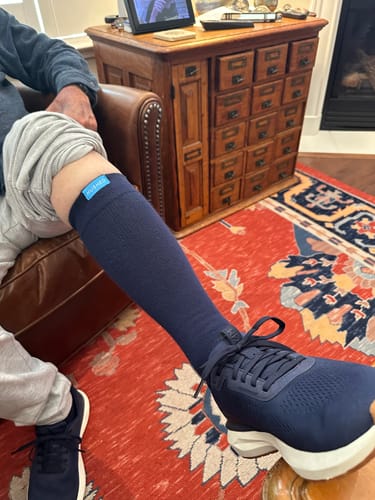 Customer wearing a navy Performance Eucalyptus Compression Sock with a matching athletic shoe.