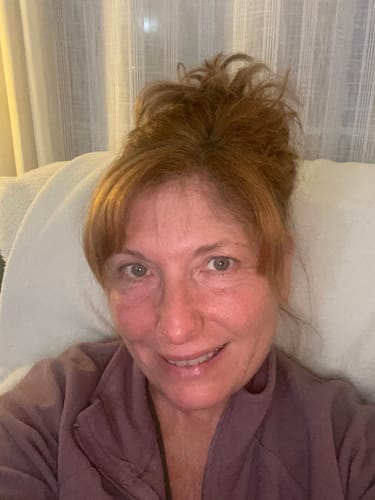 Reviewer smiling and showing their hydrated skin after using F-Balm.