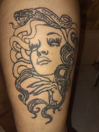 Reviewer's detailed Medusa line-art tattoo, done using the Painless Tattoo cream.