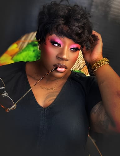Reviewer with dramatic pink makeup models the Laurel Gray Prescription Colored Contact Lenses, looking to the side.