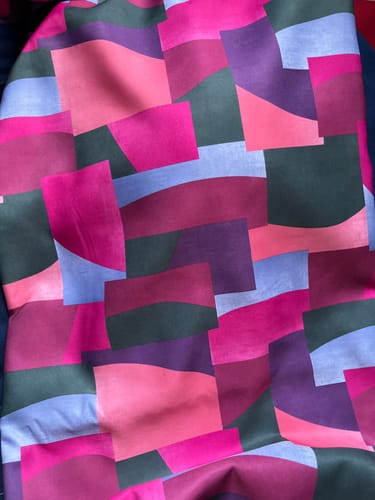 Customer's close-up of the heavy satin fabric, showing the colorful abstract block pattern with a matte finish.
