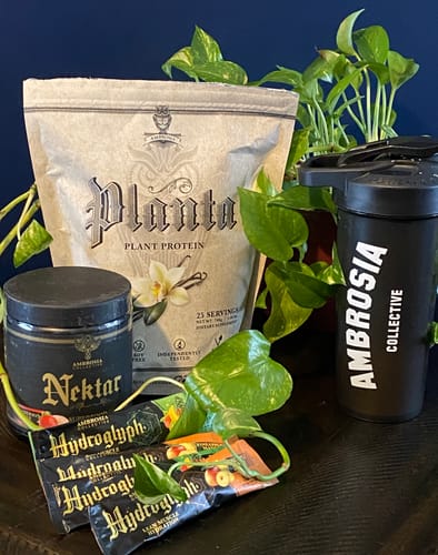 Reviewer's Health Month Bundle products including Planta protein, Nektar, Hydroglyph sticks, and a shaker, on a table.