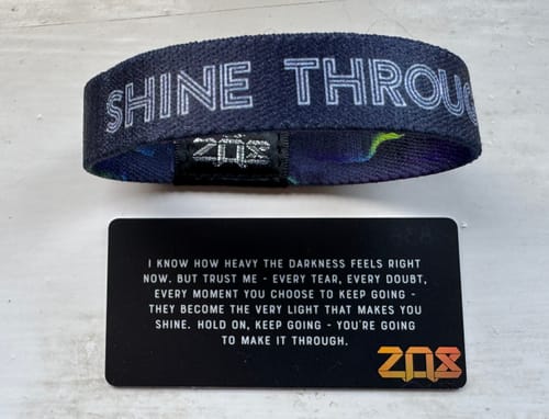 Reviewer's Shine Through Bracelet showing the inside text 'SHINE THROUGH' next to its affirmation card.