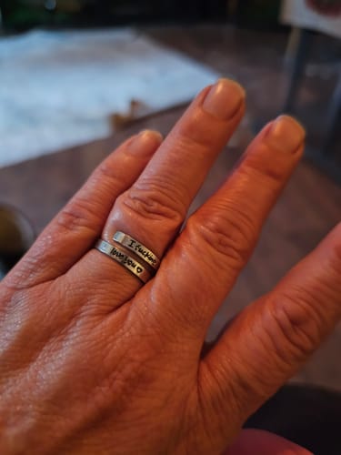 A reviewer's hand wearing the engraved, adjustable I F♡cking Love You Ring.