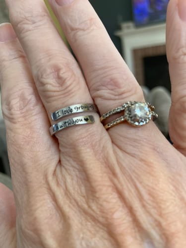 Reviewer wearing the 'I Love Growing Old With You Ring' on their middle finger next to another ring.