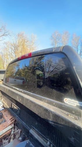 Customer's GFP PREMIUM DECAL applied to the rear window of a black pickup truck.