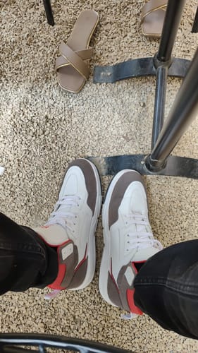 Reviewer's top-down view of the Bacca Bucci Vengeance sneakers in white with grey and red accents.